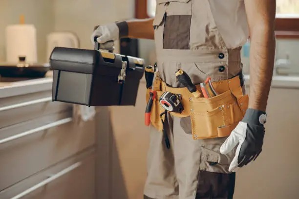 Professional handyman carrying a full toolbox, ready for a home job