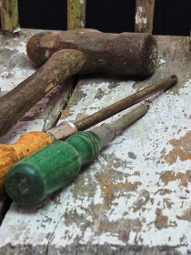 Hammer and screwdrivers laid out for a job