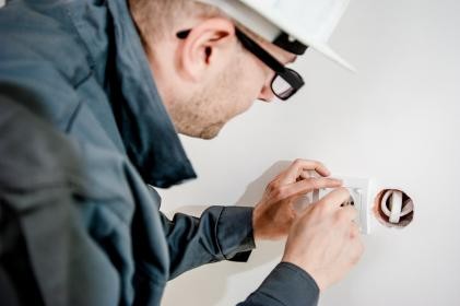 Electrician working on a wall box