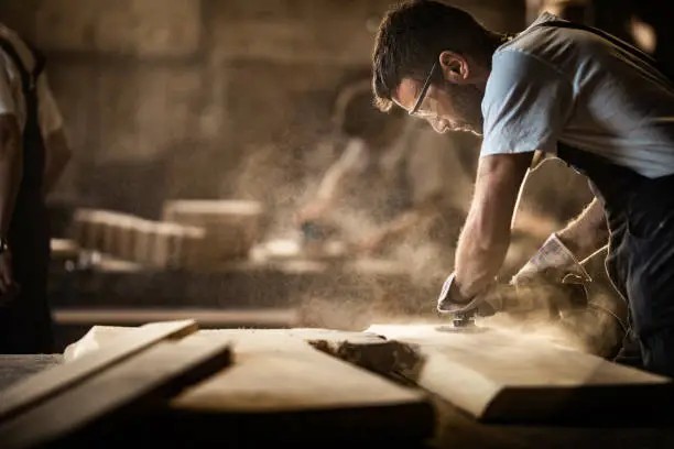 Craftsman sanding wood to a smooth finish